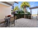 Private brick patio with table and chairs, perfect for outdoor dining at 8136 Tavistock Lakes Blvd, Orlando, FL 32827