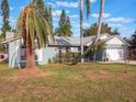 Ranch style home with palm trees and spacious lawn at 922 Fort Smith Blvd, Deltona, FL 32738