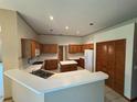 Kitchen with an island and wooden cabinets at 1017 Pearl Tree Rd, Deltona, FL 32725