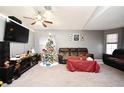 Relaxing living room with a large TV and Christmas tree at 1076 Country Cove Ct, Oviedo, FL 32766