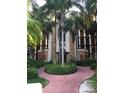 Building exterior with landscaped pathway and entrance at 12539 Floridays Resort Dr # 210D, Orlando, FL 32821