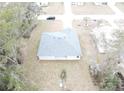 Aerial view of a new single-story home with gray roof and a large yard at 16391 Sw 17Th Terrace Rd, Ocala, FL 34473