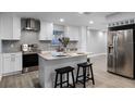 Modern kitchen featuring white shaker cabinets, granite countertops, and stainless steel appliances at 1818 Foxboro Dr, Orlando, FL 32812