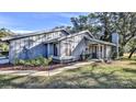 Gray single-story home with a view of the side yard and landscaping at 1890 Silver Fern Dr, Port Orange, FL 32128