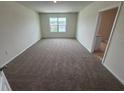 Carpeted bedroom boasts ample space and a window with bright, natural light at 2212 Lake Preserve Cir, New Smyrna Beach, FL 32168