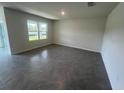 Spacious living room featuring large windows and tile flooring at 2214 Lake Preserve Cir, New Smyrna Beach, FL 32168