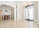 Elegant entryway with tile floors and chandelier at 2566 Ballard Ave, Orlando, FL 32833