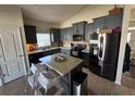 Spacious kitchen featuring dark gray cabinets, stainless steel appliances, and an island at 3105 Dasha Palm Dr, Kissimmee, FL 34744