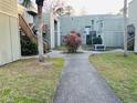 Courtyard with walkway, landscaping, and building exteriors at 318 Scottsdale Sq # 318, Winter Park, FL 32792