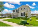 Two-story house with gray siding, dark shutters, and a basketball hoop, viewed from the side at 332 Bow Ln, Haines City, FL 33844