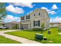 Well-maintained two-story home featuring a lush lawn and a convenient two-car garage at 332 Bow Ln, Haines City, FL 33844