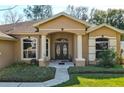 House entrance with double doors and columns at 345 Via Bianca Dr, Davenport, FL 33896