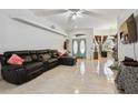 Spacious living room with a leather sectional sofa and tile floors at 345 Via Bianca Dr, Davenport, FL 33896