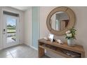 Bright and airy foyer with a large mirror and console table at 3555 Chinkapin Oak Ln, Apopka, FL 32703