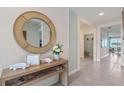 Open and bright hallway with a decorative mirror and console table at 3555 Chinkapin Oak Ln, Apopka, FL 32703