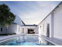 Luxury pool with blue tiles and a view of the home at dusk at 402 N Pollard St, Oakland, FL 34787