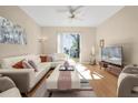 Bright living room with light-colored furniture and sliding glass doors at 4213 Whitemoor Ct, Clermont, FL 34711