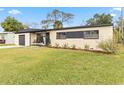 Newly renovated ranch house with attractive landscaping and a spacious yard at 4301 Lancashire Ln, Orlando, FL 32812