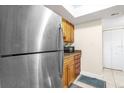 Stainless steel refrigerator, wooden cabinets and granite countertop at 4767 S Texas Ave # 4767C, Orlando, FL 32839