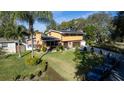 Two-story house, paved driveway, and lush green lawn at 5006 Monet Ave, Belle Isle, FL 32812