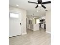 Bright living room with tile floors, modern kitchen, and ceiling fan at 660 Encino Way, Altamonte Springs, FL 32714