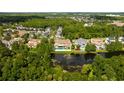 Lakefront property with lush landscaping and neighboring homes at 717 Eastlawn Dr, Kissimmee, FL 34747