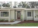 Inviting front entrance with a decorative door and landscaping at 748 N Gretna Ct, Winter Springs, FL 32708