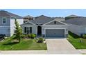 This single-story house features a gray exterior and a two-car garage at 764 Sarner Pass Way, Winter Haven, FL 33881