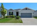 Two-car garage and well-maintained lawn add to this home's appeal at 764 Sarner Pass Way, Winter Haven, FL 33881