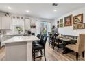 Modern kitchen with white cabinets, island, and dining area at 914 Spring Palms Loop, Orlando, FL 32828