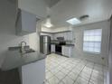 Kitchen with stainless steel appliances and grey countertops at 113 W 1St St, Debary, FL 32713