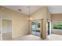 Dining room with access to backyard and a chandelier at 14783 Yorkshire Run Dr, Orlando, FL 32828