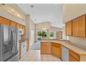 Kitchen features wood cabinets, stainless steel appliances, and tile floor at 14783 Yorkshire Run Dr, Orlando, FL 32828