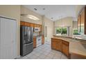 Bright kitchen with stainless steel appliances and light wood cabinets at 14783 Yorkshire Run Dr, Orlando, FL 32828