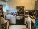 Small kitchen with white cabinets and appliances at 198 Scottsdale Sq # 198, Winter Park, FL 32792