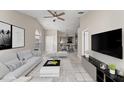 Bright, modern living room with tile floors and open concept design at 2317 Santa Lucia St, Kissimmee, FL 34743