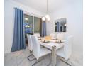 Elegant dining room showcases modern lighting, stylish mirror, and seating for six at 2974 Protagonist St, Kissimmee, FL 34746
