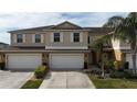 Front view of a two-story townhome with a double garage at 3018 Bargate St, Orlando, FL 32824