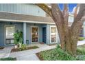 Neat townhome with covered entryway, landscaping, and a large oak tree at 421 Sheoah Blvd # 5, Winter Springs, FL 32708