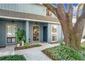 Light blue townhome with covered entry and mature landscaping at 421 Sheoah Blvd # 5, Winter Springs, FL 32708
