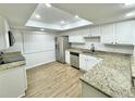 Bright kitchen with white cabinets, granite counters, and stainless steel appliances at 473 Oak Haven Dr # 473, Altamonte Springs, FL 32701