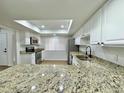 Bright kitchen with white cabinets, granite counters, and stainless steel appliances at 473 Oak Haven Dr # 473, Altamonte Springs, FL 32701