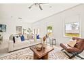 Spacious living room with light beige couch and wooden coffee table at 6394 Chorus Dr, Mascotte, FL 34753