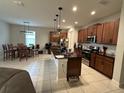 Open kitchen with island, dark wood cabinets, and breakfast nook at 7835 Syracuse Dr, Clermont, FL 34714