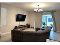 Spacious living room with large sectional sofa and mounted TV at 7835 Syracuse Dr, Clermont, FL 34714