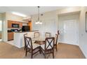 Small dining area with glass-top table and four chairs at 8101 Resort Village Dr, Orlando, FL 32821