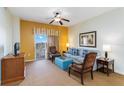 Living room with sofa, chairs, and access to balcony at 8101 Resort Village Dr, Orlando, FL 32821