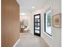 Bright entryway with wood accent wall and view to kitchen at 9697 Bryanston Dr, Orlando, FL 32827