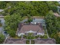 Aerial view of townhomes with brown roofs and parking area at 5356 Diplomat Ct # 107, Kissimmee, FL 34746