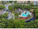 Aerial view showing a community pool, spa, and clubhouse at 5356 Diplomat Ct # 107, Kissimmee, FL 34746